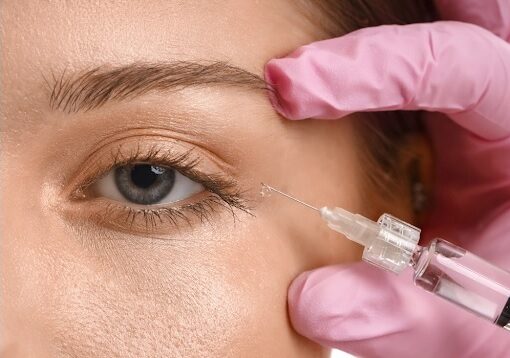 A woman receiving Botox treatment for under-eye wrinkles in a clinical setting