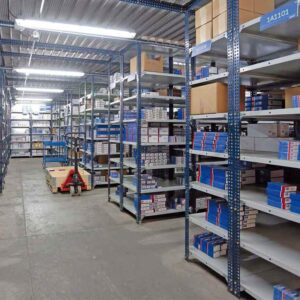 Heavy-duty slotted angle racks for industrial and warehouse storage.